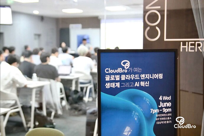 The image shows a room filled with people working at their desks, with a poster in the foreground advertising an AI forum event presented by CloudBro. (Captioned by AI)