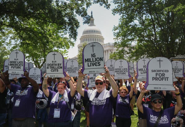 People hold placards at the Capitol.
