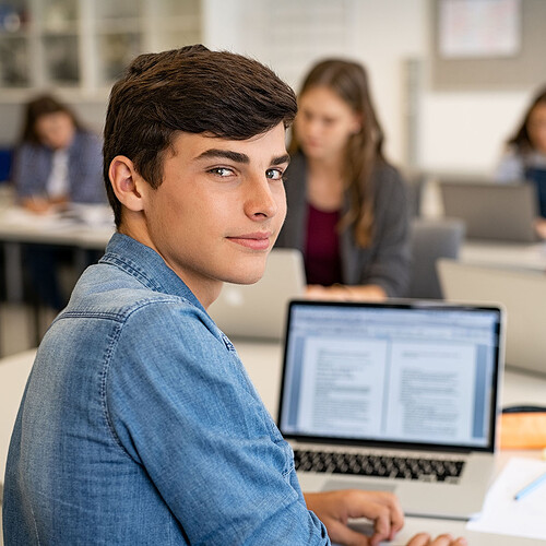 school-guy-working-on-laptop-during-class-2023-11-27-04-51-13-utc