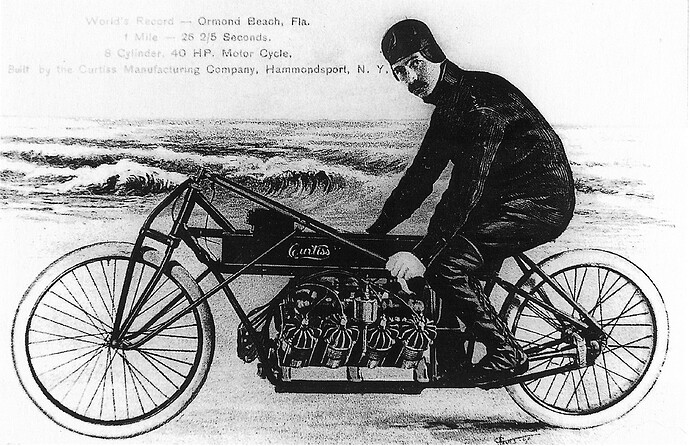 https://upload.wikimedia.org/wikipedia/commons/f/fa/Glenn_Curtiss_on_his_V-8_motorcycle,_Ormond_Beach,_Florida_1907.jpg