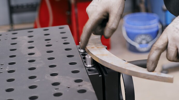 The Sidekick Vise holding a curved piece of metal.